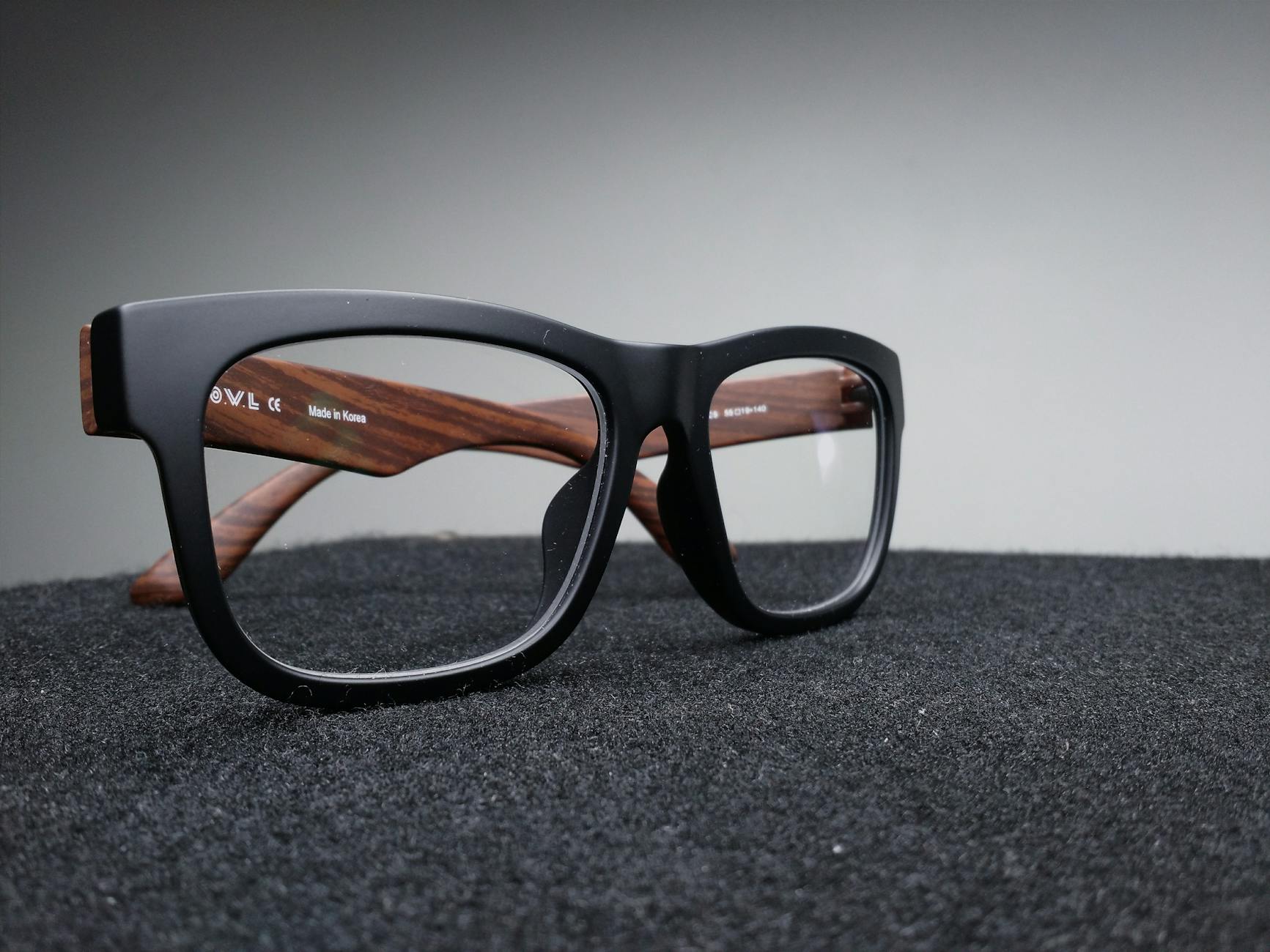 black framed eyeglasses on black surface