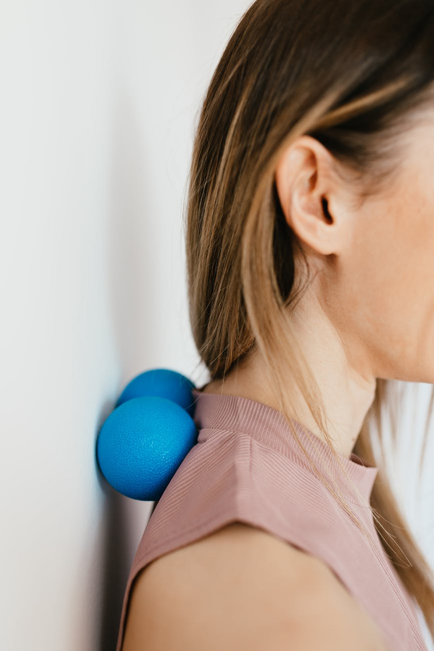 crop woman massaging sore neck and muscle stretching